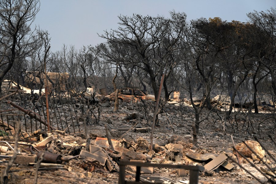 FILE - Burnt trees and a car after yesterday's fire in Mandra, west of Athens, on Wednesday, July 19, 2023. Europe is the fastest-warming continent and its temperatures are rising at roughly twice the global average, two top climate monitoring organizations reported Monday, April 22, 2024, warning of the consequences for human health, glacier melt and economic activity. (AP Photo/Thanassis Stavrakis, File)