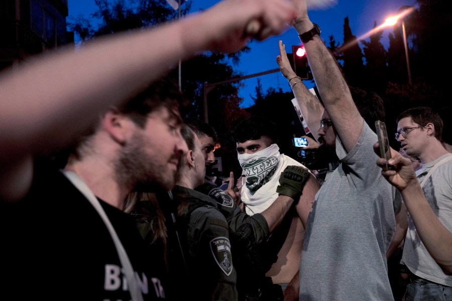 Police restrain a supporter of Israeli-American hostage Hersh Goldberg-Polin, who was kidnapped on Oct. 7, 2023, during a protest outside of Israeli Prime Minister Benjamin Netanyahu's residence to demand a deal for the immediate release of all hostages, after Hamas released a video of Goldberg-Polin, in Jerusalem, Wednesday, April 24, 2024. (AP Photo/Maya Alleruzzo)