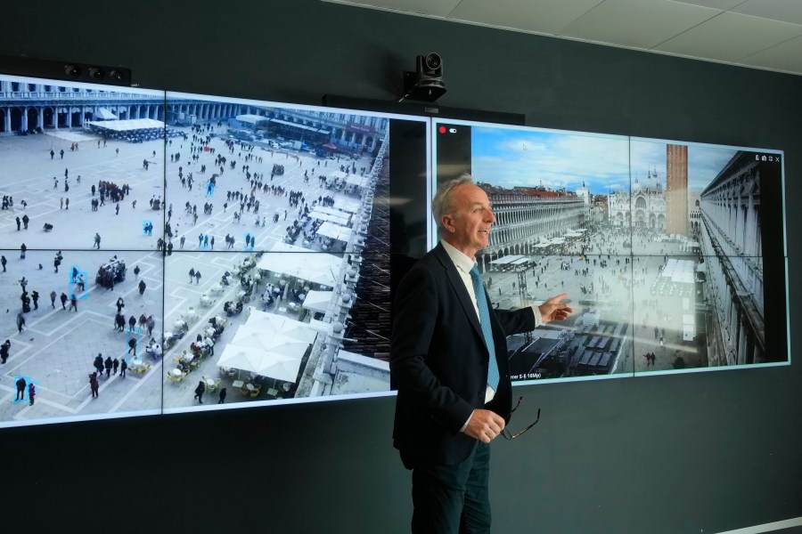 Marco Bettini, director of Venis Informatics System, gestures as he talks to reporters at the police Venice control room, in Venice, Italy, Wednesday, April 24, 2024. The lagoon city of Venice begins a pilot program Thursday, April 25, 2024 to charge daytrippers a 5 euro entry fee that authorities hope will discourage tourists from arriving on peak days. Officials expect some 10,000 people will pay the fee to access the city on the first day, downloading a QR code to prove their payment. (AP Photo/Luca Bruno)