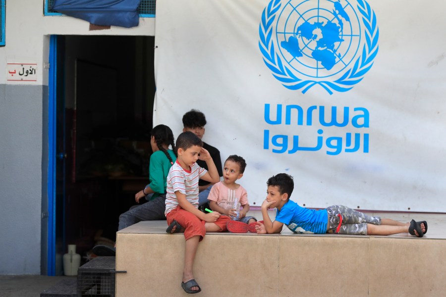 FILE - Palestinian children who fled with their parents from their houses in the Palestinian refugee camp of Ein el-Hilweh, gather in the backyard of an UNRWA school, in Sidon, Lebanon, Sept. 12, 2023. An independent review released Monday, April 22, 2024, of the neutrality of UNRWA, the U.N. agency helping Palestinian refugees, has found that Israel never expressed concern about anyone on the staff lists it has received annually since 2011. The review was carried out after Israel alleged that a dozen employees of the agency had participated in Hamas’ Oct. 7 attacks. (AP Photo/Mohammed Zaatari, File)