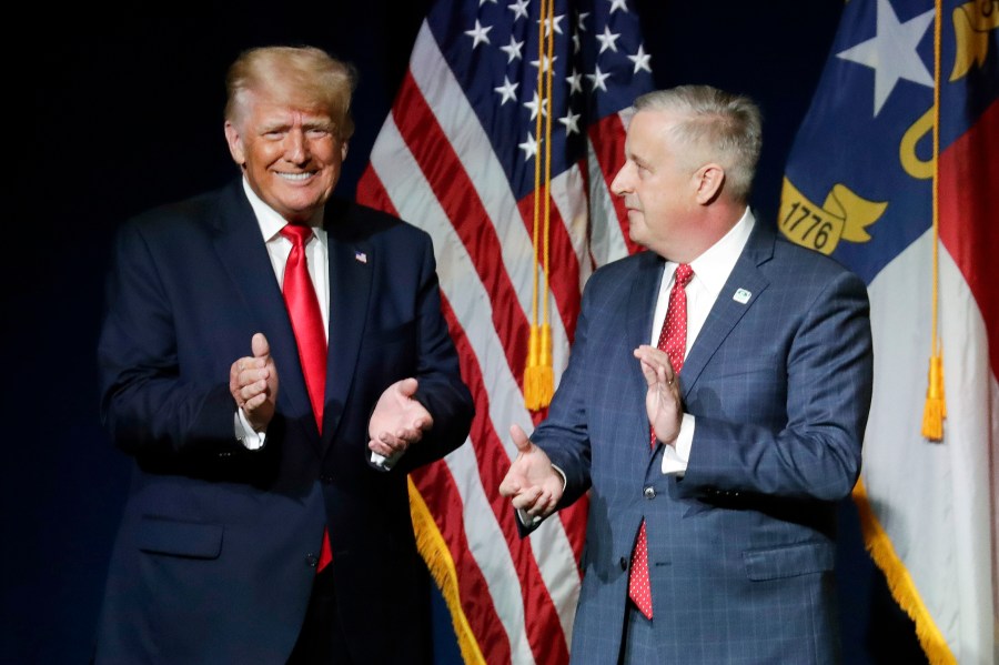 Former President Trump and Michael Whatley stand side-by-side at an event.