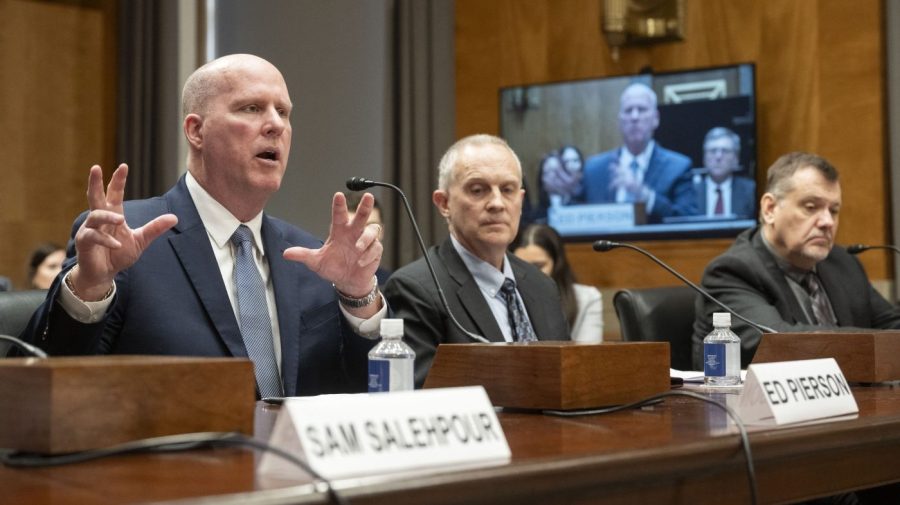 Participants in a House committee hearing speak.