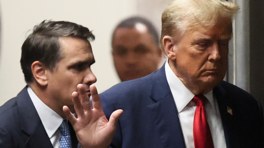 Former President Trump walks with his attorney Todd Blanche in Manhattan criminal court.