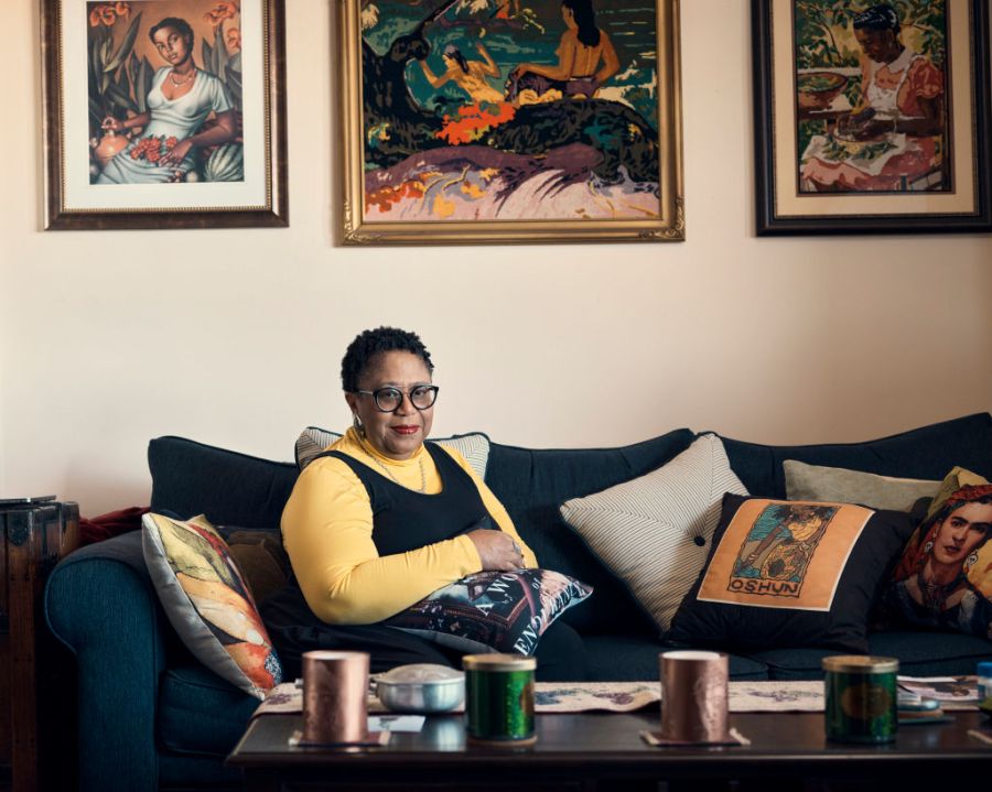 Dahlma Llanos-Figueroa sits on a couch in her home in the Bronx in New York City.