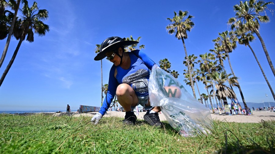 Vangie Peterson helps clean up the trash at Venice Beach for Earth Day on April 22, 2023, in Los Angeles, California.