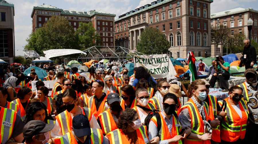 Columbia University faculty and staff gather on the campus in solidarity with student protesters who are demonstrating against the university's investments in Israel, Monday, April 29, 2024, in New York.