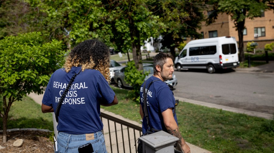 Shamso Iman, left, and Dane Haverly, with the Behavioral Crisis Response team, leave the scene after responding to a distress call in Minneapolis, Minn., on Tuesday, July 11, 2023.