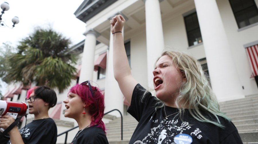 Seneca Bristol, of the Women Voices of Southwest Florida chants along with other protesters and activists.