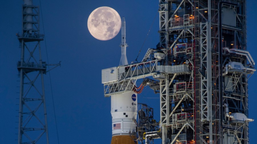 A full moon is seen behind the Artemis I Space Launch System (SLS) and Orion spacecraft, atop the mobile launcher, are prepared for a wet dress rehearsal to practice timelines and procedures for launch, at Launch Complex 39B at NASA's Kennedy Space Center in Florida on June 14, 2022.