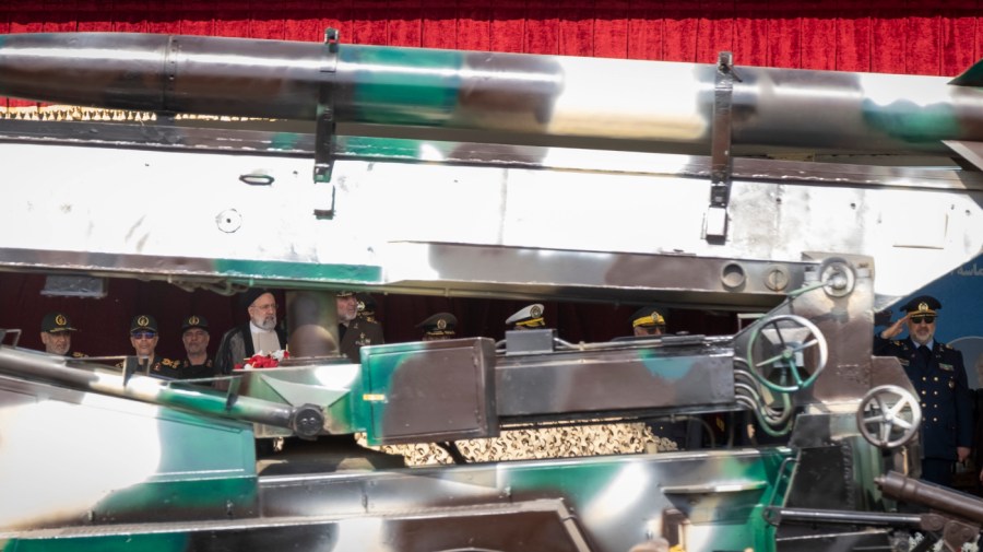 Iranian President Ebrahim Raisi (4th L) is looking at an Iranian missile being carried by a truck while standing with the Islamic Revolutionary Guard Corps (IRGC) commanders (L) during a military parade marking Iran's Army Day anniversary at an Army military base in Tehran, Iran, on April 17, 2024.