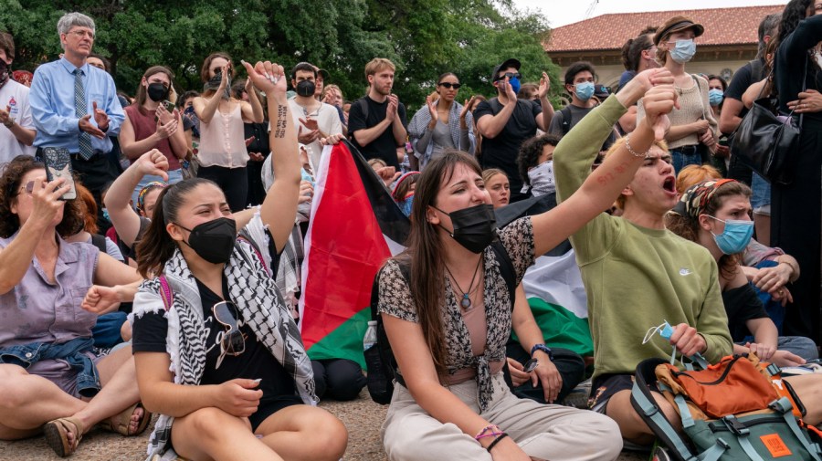 Protesters sit on the campus of the University of Texas at Austin.