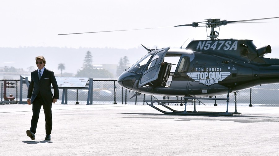 Tom Cruise walks to the red carpet after riding a helicopter to the world premiere of "Top Gun: Maverick" on Wednesday, May 4, 2022, at the USS Midway in San Diego.