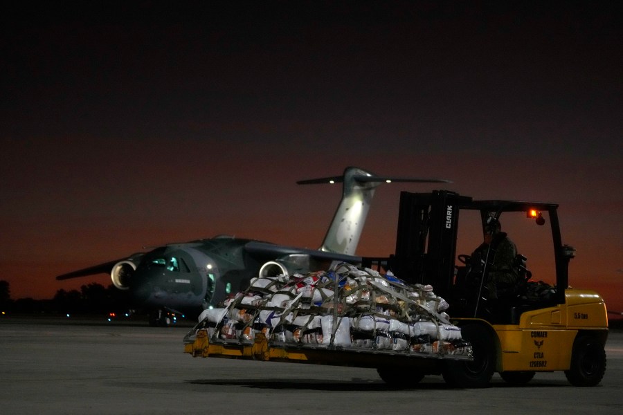 Military prepare to load supplies on an Air Force plane, to transport to victims and people who lost their homes from floods caused by heavy rains in the cities of the Rio Grande do Sul state, at the Air Base in Brasilia, Brazil, Saturday, May 11, 2024. (AP Photo/Eraldo Peres)