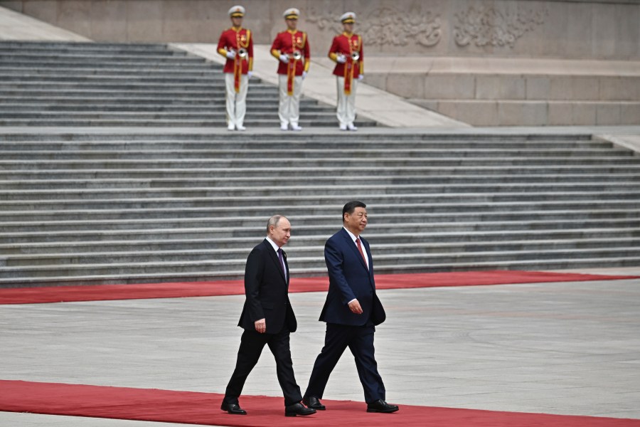 Chinese President Xi Jinping, right, and Russian President Vladimir Putin walk during an official welcome ceremony in Beijing, China, on Thursday, May 16, 2024. (Sergei Bobylev, Sputnik, Kremlin Pool Photo via AP)