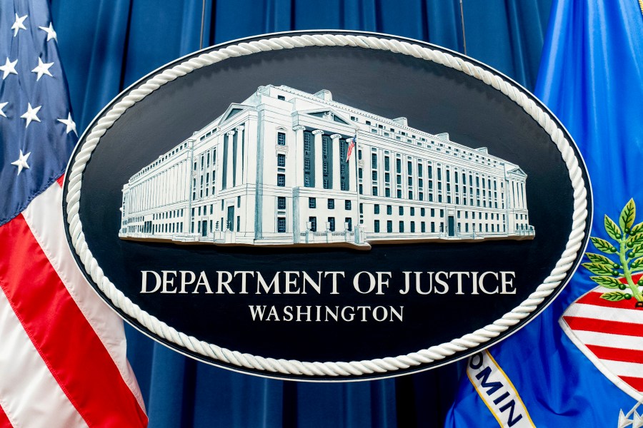 FILE - The seal for the Justice Department is photographed in Washington, Nov. 18, 2022. The Justice Department has announced three arrests in a complex stolen identity scheme that officials say generates enormous proceeds for the North Korean government, including for its weapons program. (AP Photo/Andrew Harnik, File)