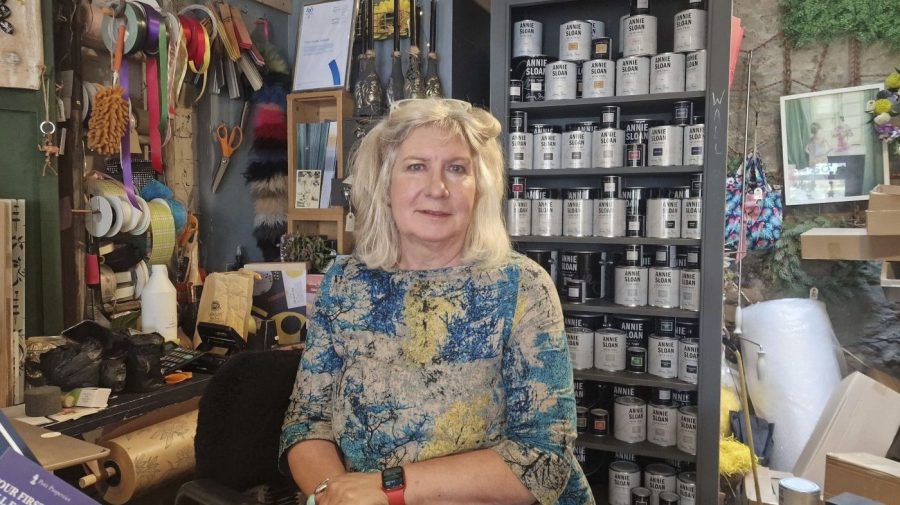 Sally Dart, who runs Flotsam 50 near Brixham Harbour, a shop that sells artwork, furniture, and flowers poses in Brixham, Friday May 17, 2024. Around 16,000 homes and businesses in the Brixham area of Devon were told to boil water after cryptosporidium, a microscopic parasite that causes diarrhea, was found in the water. Sally Dart, who runs a housewares shop near Brixham Harbor, said people in town first began feeling ill two weeks ago during a pirate festival. "No one was checking the quality of the water and we’ve all got sick and it’s stupid,” she said. (Piers Mucklejohn/PA via AP)