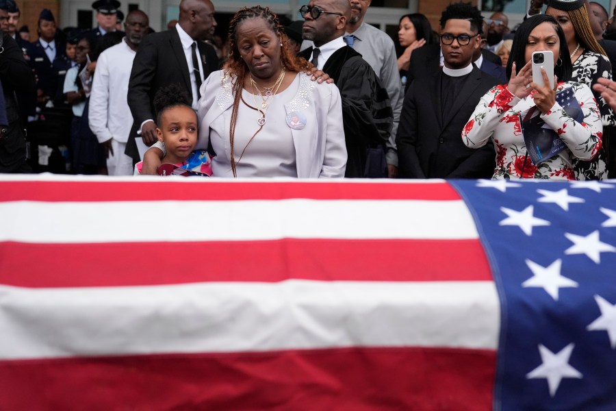 Chantemekki Fortson the mother of slain airman Roger Fortson, right, along with family watch Fortson's casket as they leave for a cemetery during his funeral at New Birth Missionary Baptist Church, Friday, May 17, 2024, in Stonecrest, Ga. (AP Photo/Brynn Anderson)