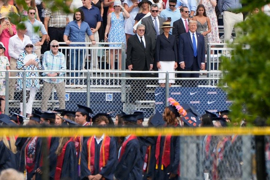 Republican presidential candidate former President Donald Trump, standing right with Melania Trump and her father, Viktor Knavs, attends a graduation ceremony for his son Barron at Oxbridge Academy Friday, May 17, 2024, in West Palm Beach, Fla. (AP Photo/Lynne Sladky)