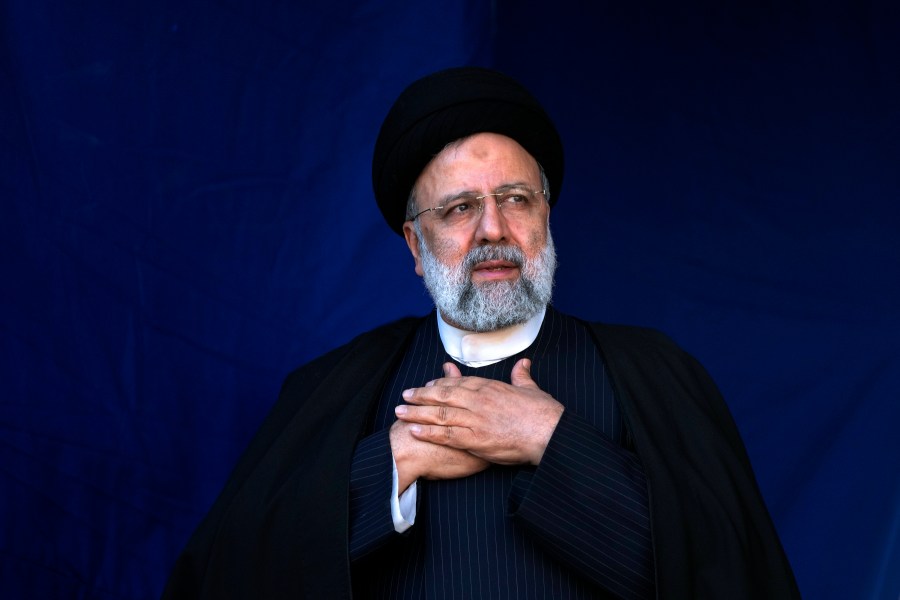 FILE- Iranian President Ebrahim Raisi places his hands on his heart as a gesture of respect to the crowd during the funeral ceremony of the victims of Wednesday's bomb explosion in the city of Kerman about 510 miles (820 kms) southeast of the capital Tehran, Iran, Jan. 5, 2024. A helicopter carrying Iranian President Ebrahim Raisi suffered a “hard landing” on Sunday, May 19, 2024, Iranian state television reported, without immediately elaborating. (AP Photo/Vahid Salemi, File)