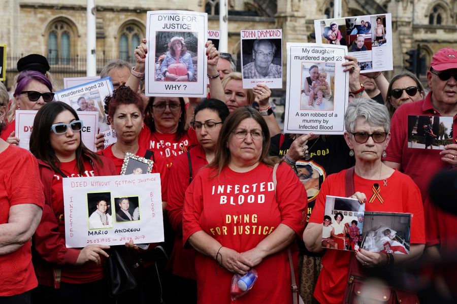 Infected blood campaigners gather in Parliament Square, ahead of the publication of the final report into the scandal, in London, Sunday, May 19, 2024. The final report of the U.K.’s infected blood inquiry will be published Monday, six years after it started its work. The inquiry heard evidence as to how thousands of people contracted HIV or hepatitis from transfusions of tainted blood and blood products in the 1970s and 1980s. (Aaron Chown/PA via AP)