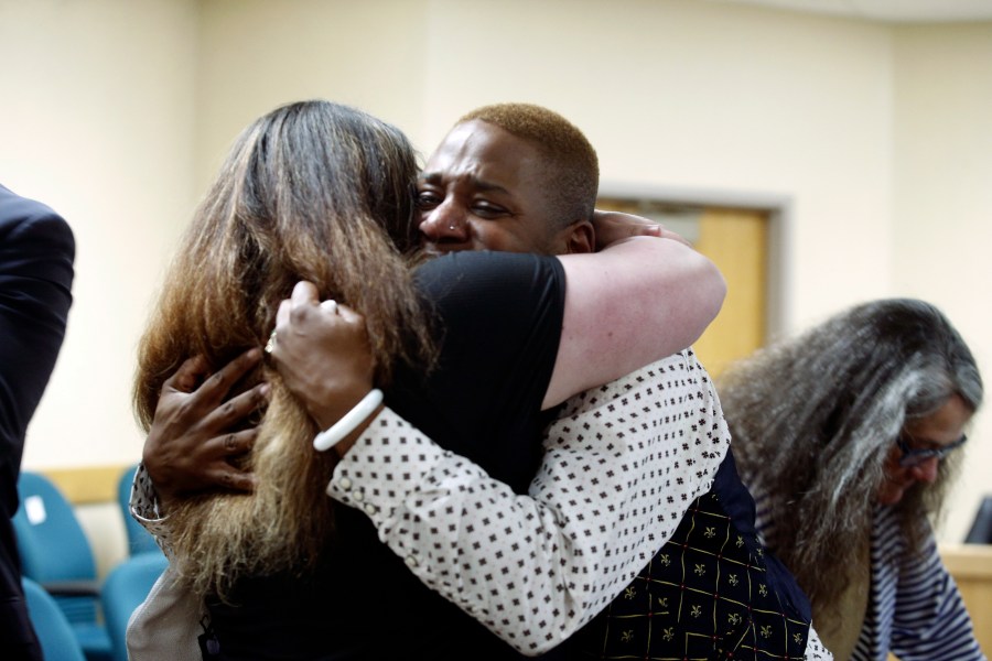 Eric Posey, of Post Falls, Idaho, embraces a supporter in court, after a jury awarded him more than $1.1 million in damages in his defamation lawsuit against conservative blogger Summer Bushnell, Friday, May 24, 2024, in Coeur D'Alene, Idaho. Posey said he suffered harassment and death threats after Bushnell falsely accused him of exposing himself to minors during a performance in 2022. (Kaye Thornbrugh/Coeur D'Alene Press via AP)