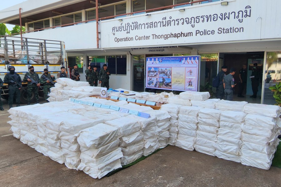 FILE - Thai soldiers stand beside seized 50 million methamphetamine pills hidden in sacks during a news conference at Thongphaphum Police station in Kanchanaburi province, Thailand, on Dec. 13, 2023. The U.N. drug fighting agency says East and Southeast Asia are awash in record amounts of methamphetamine and other synthetic drugs, originating largely from the cross-border area known as the Golden Triangle, historically known for growing opium and hosting many of the labs that converted it to heroin. (AP Photo/Keskawe Chongchareon)