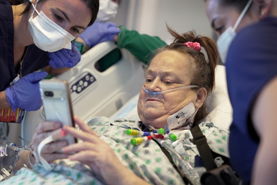 FILE - Lisa Pisano looks at photos of her dog after her surgeries at NYU Langone Health in New York on Monday, April 22, 2024. Doctors had to remove a transplanted pig kidney from Pisano and put her back on dialysis just 47 days later – because the heart disease she also suffers damaged the new organ. Pisano was only the second patient ever to receive a kidney from a gene-edited pig, and NYU Langone Health announced Friday, May 31, that she is stable after removal of the kidney. (AP Photo/Shelby Lum, File)