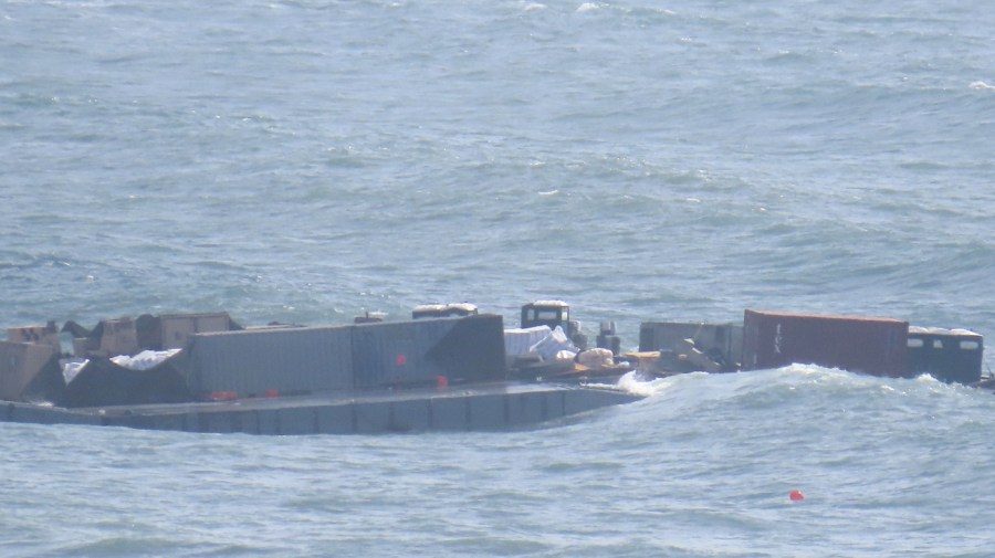 The damaged pier is seen floating in the sea.