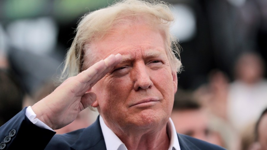 Former President Donald Trump salutes during opening ceremonies as he attends the NASCAR Coca-Cola 600 auto race, Sunday, May 26, 2024, in Concord, N.C. It is the first time that a president or former president has attended a race at Charlotte Motor Speedway. (AP Photo/Chris Seward)