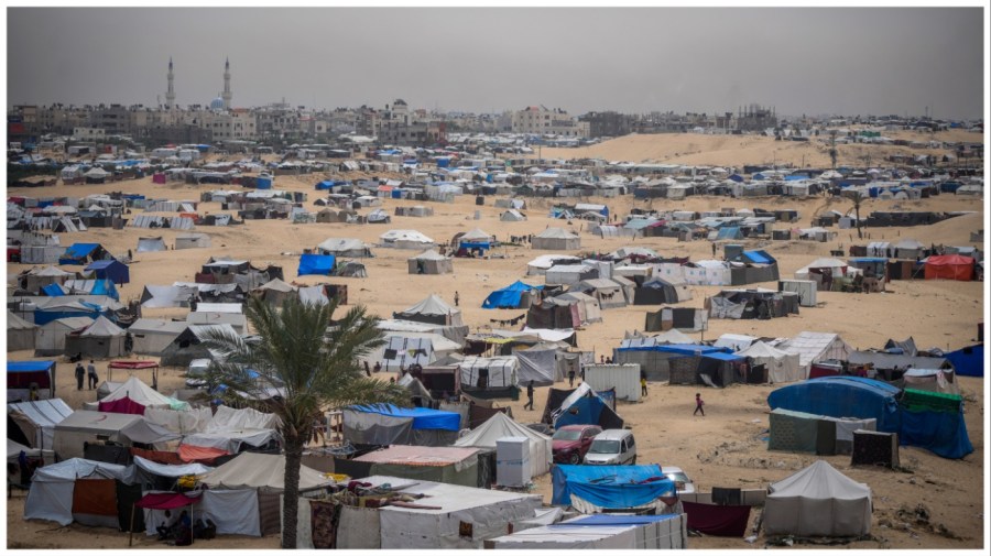 Palestinians displaced by the Israeli air and ground offensive on the Gaza Strip walk through a makeshift tent camp in Rafah, Gaza, Friday, May 10, 2024. (AP Photo/Abdel Kareem Hana)