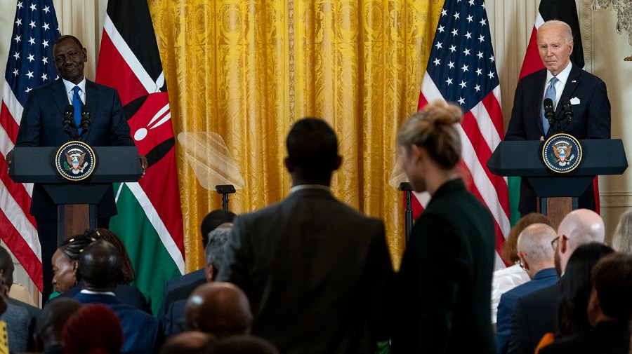 Kenyan President William Ruto and President Biden listen to a question during a press conference.