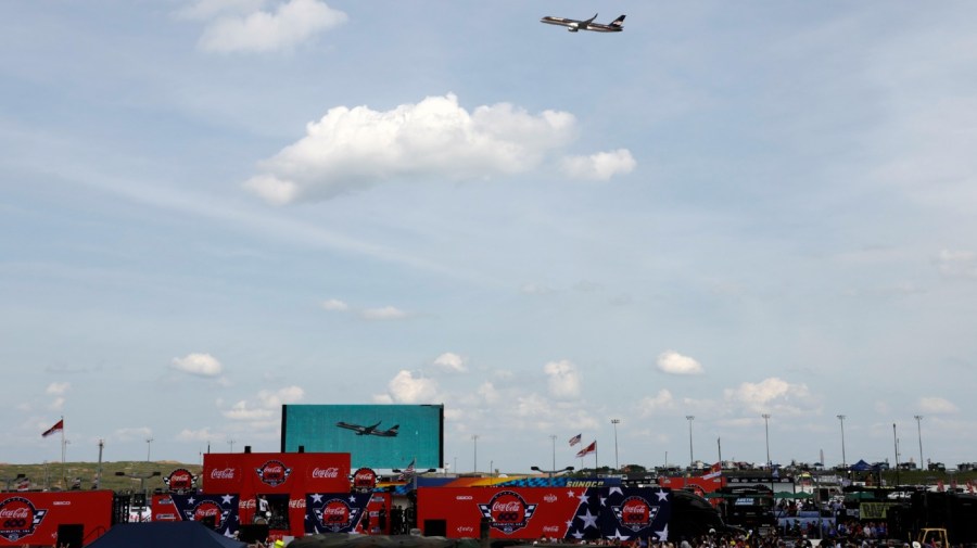 Former President Donald Trump's jet flies over the crowd before he attends the NASCAR Coca-Cola 600 auto race, Sunday, May 26, 2024, in Concord, N.C. It is the first time that a president or former president has attended a race at Charlotte Motor Speedway. (AP Photo/Chris Seward)