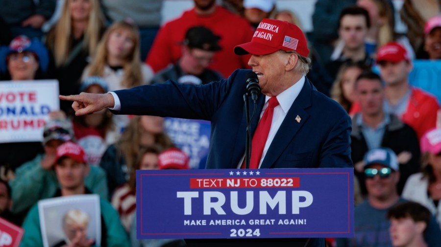 Former President Trump points off to the side while speaking during a campaign event.