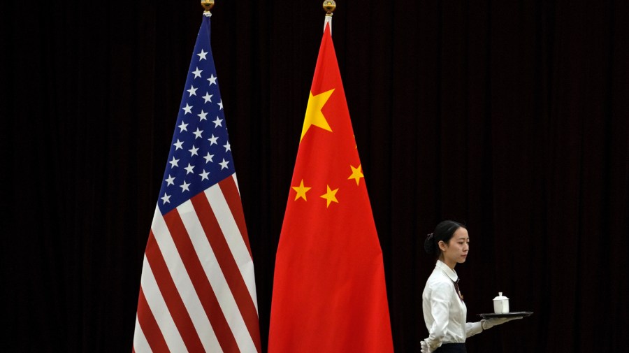 A hostess walks by the national flags of the United States and China ahead of the bilateral meeting between U.S. Treasury Secretary Janet Yellen and Chinese Vice Premier He Lifeng, at the Guangdong Zhudao Guest House in southern China's Guangdong province, April 6, 2024.