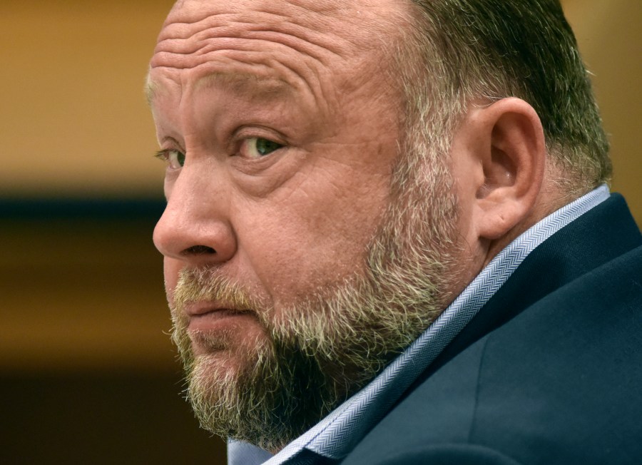 FILE - Infowars founder Alex Jones appears in court to testify during the Sandy Hook defamation damages trial at Connecticut Superior Court, Sept. 22, 2022, in Waterbury, Conn. Relatives of victims of the Sandy Hook Elementary School shooting are asking a bankruptcy judge to liquidate Jones' media company including Infowars instead of allowing him to reorganize his business, as they seek to collect on $1.5 billion in lawsuit verdicts against him. (Tyler Sizemore/Hearst Connecticut Media via AP, Pool, File)