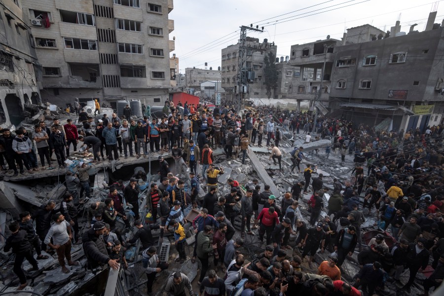 FILE - Palestinians search for bodies and survivors in the rubble of a residential building destroyed in an Israeli airstrike, in Rafah southern Gaza Strip, on Dec. 20, 2023. An AP analysis of Gaza Health Ministry data finds the proportion of Palestinian women and children being killed in the Israel-Hamas war appears to have declined sharply. Israel faces heavy international criticism over unprecedented levels of civilian casualties in Gaza. (AP Photo/Fatima Shbair)