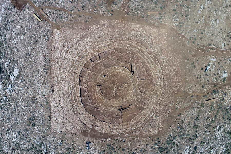 In this undated photo provided by the Greek Culture Ministry on Tuesday, June 11, 2024, the ruins of a 4,000-year-old hilltop building newly discovered on the island of Crete are seen from above. The wheel-shaped structure is puzzling archaeologists and threatening to disrupt a major airport project on the tourism-reliant island. Greece's Culture Ministry said Tuesday that it's a "unique and extremely interesting find" from Crete's Minoan civilization, famous for its sumptuous palaces, flamboyant art and enigmatic writing system. (Greek Culture Ministry via AP)