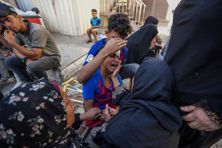 Palestinians mourn their relatives killed in the Israeli bombardment of the Gaza Strip in a hospital in Deir al Balah on Tuesday, June 18, 2024. (AP Photo/Abdel Kareem Hana)