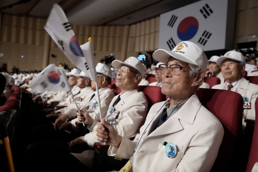 Korean War veterans wave the national flags during a ceremony to mark the 74th anniversary of the outbreak of the Korean War in Daegu, South Korea, Tuesday, June 25, 2024. (AP Photo/Ahn Young-joon, Pool)