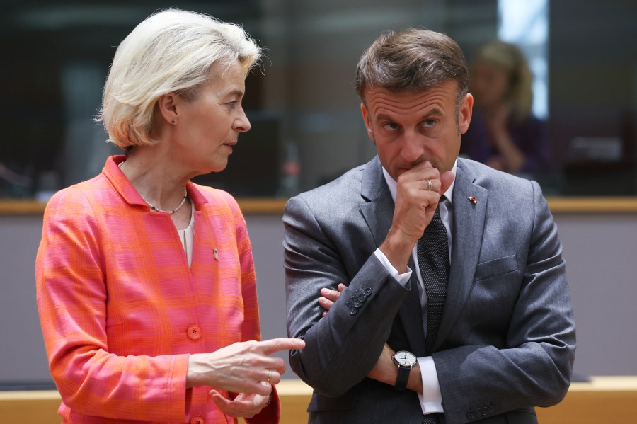 FILE - French President Emmanuel Macron, right, speaks with European Commission President Ursula von der Leyen during a round table meeting at an EU summit in Brussels, Thursday, June 27, 2024. Emmanuel Macron once appeared as a bold, young leader offering to revive France through radical pro-business, pro-European policies so that voters have "no reason anymore" to vote for the extremes. Seven years after he was first elected, his call for snap elections weakens him at home and abroad, while it appears to propel the far right on the verge of power. (Olivier Hoslet, Pool Photo via AP, File)