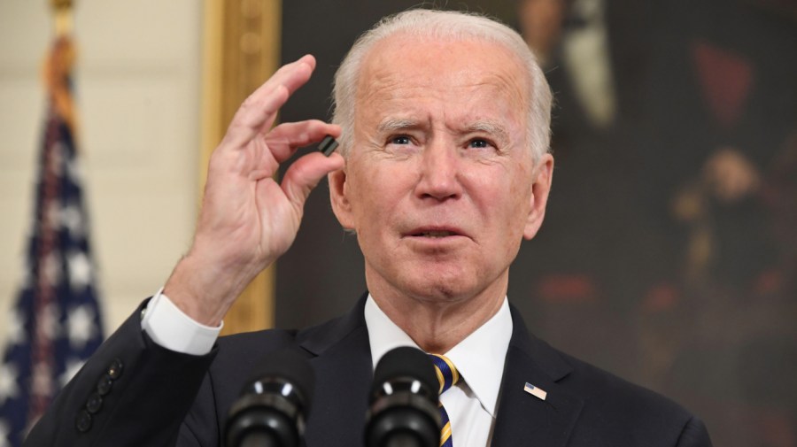 US President Joe Biden holds a microchip as he speaks before signing an executive order on securing critical supply chains, in the State Dining Room of the White House in Washington, DC, February 24, 2021. (Photo by SAUL LOEB/AFP via Getty Images)