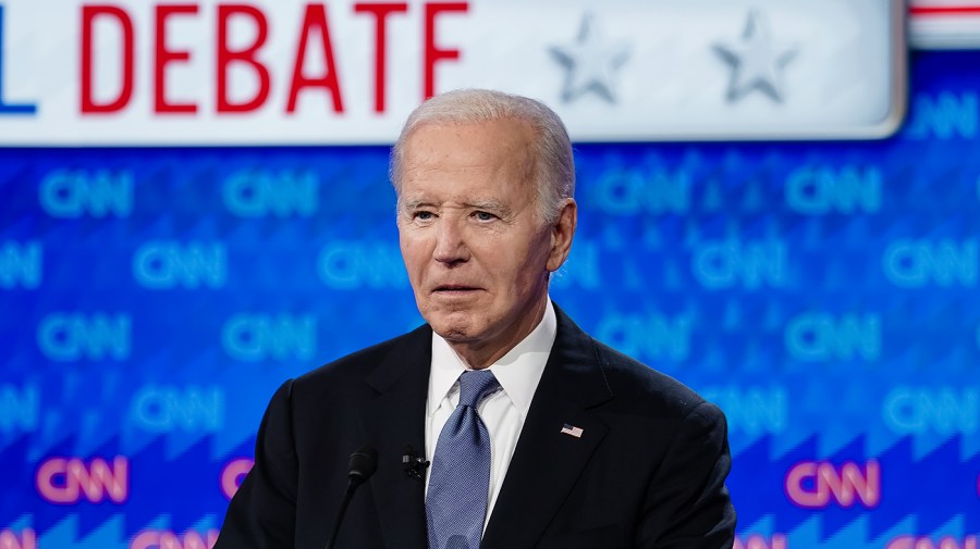 President Biden is seen on stage during a debate.