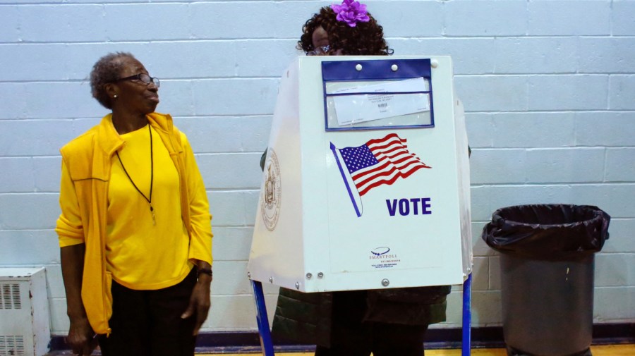 A voter asks an election worker a question as she votes at Samuels Community Center in the presidential election November 8, 2016 in the Harlem neighborhood of New York City. (Photo by KENA BETANCUR/AFP via Getty Images)