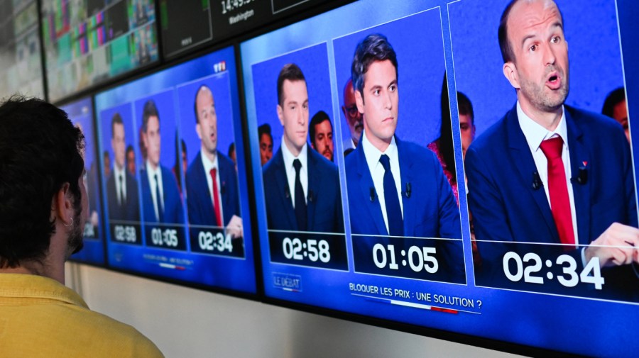 A photograph of monitors in a media control room at AFP headquarters in Paris, displays (From L) French far-right Rassemblement National (RN) party President and lead MEP Jordan Bardella, France's Prime Minister Gabriel Attal and French MP of left wing party La France Insoumise (LFI) Manuel Bompard during a political debate broadcasted on French TV channel TF1, on June 25, 2024, ahead of France's snap elections for a new national assembly on June 30 and July 7, 2024. (Photo by Stefano RELLANDINI / AFP) (Photo by STEFANO RELLANDINI/AFP via Getty Images)