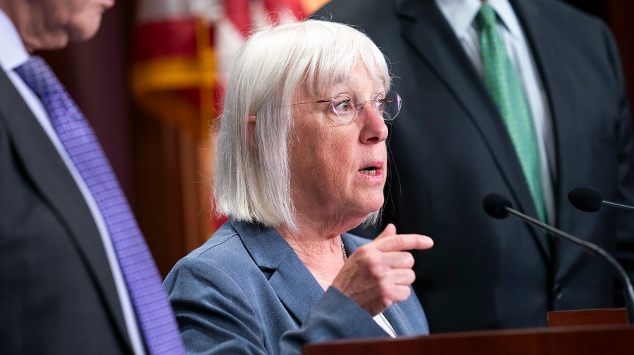 Senator Patty Murray gestures while speaking to reporters.