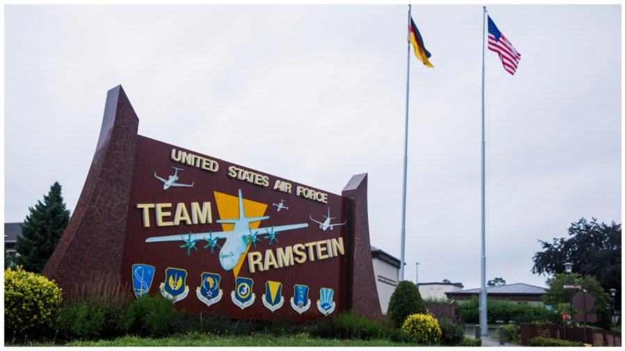 The flags of the United States and Germany fly behind a sign at Ramstein Air Base, Germany Wednesday, July 30, 2014. (AP Photo/Lucas Jackson, Pool)