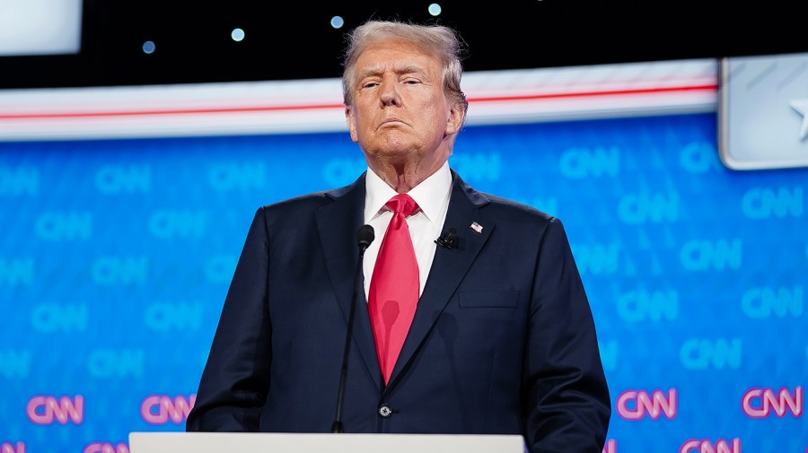 Former President Trump stands on the stage during a debate.