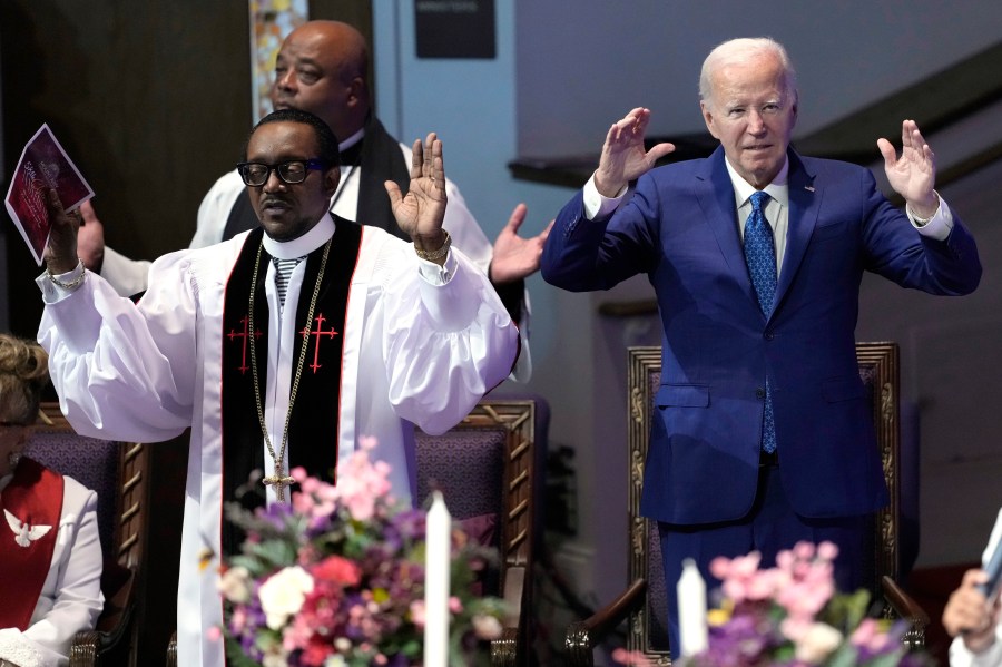 President Joe Biden, right, and pastor Dr. J. Louis Felton pray at a church service at Mt. Airy Church of God in Christ, Sunday, July 7, 2024, in Philadelphia. (AP Photo/Manuel Balce Ceneta)