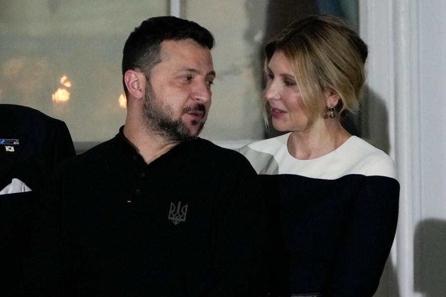 Ukrainian President Volodymyr Zelenskyy and his wife Olena Zelenska stand on the Blue Room balcony as President Joe Biden and first lady Jill Biden welcome NATO allies and partners to the White House in Washington, Wednesday, July 10, 2024, on the South Lawn for the 75th anniversary of the NATO Summit. (AP Photo/Susan Walsh)