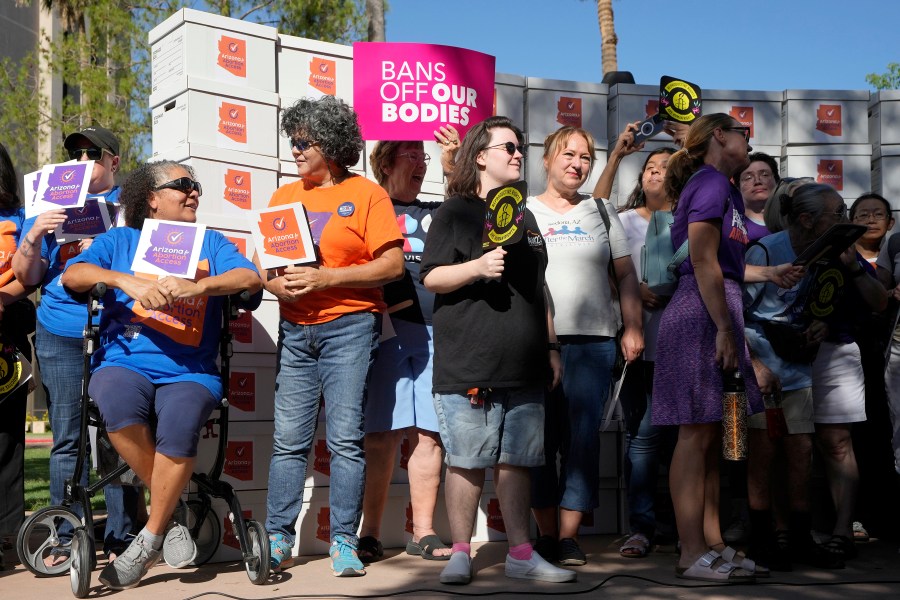 FILE - Arizona abortion-rights supporters gather for a news conference prior to delivering over 800,000 petition signatures to the capitol to get abortion rights on the November general election ballot Wednesday, July 3, 2024, in Phoenix. Abortion access ballot measures are the center of a new wave of legal and procedural questions across the U.S., including Arizona, where there's a dispute over language to describe a measure. (AP Photo/Ross D. Franklin, File)